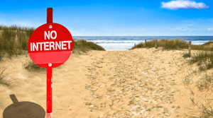 Red sign with the Words No Internet on an Sunny Beach