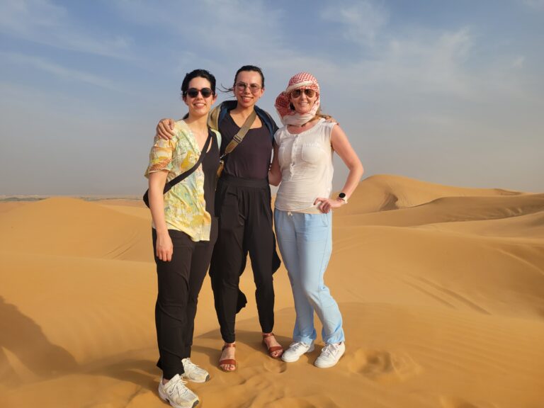 Three women in a desert.