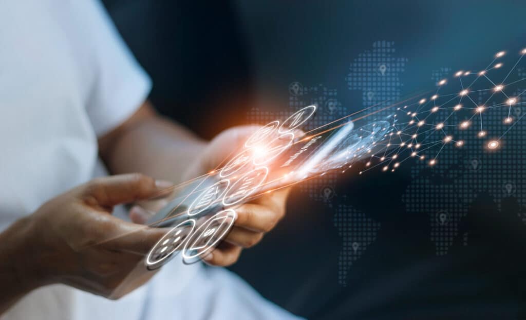 An image of hands holding a device with data flowing out of it, illustrating data sharing strategies.